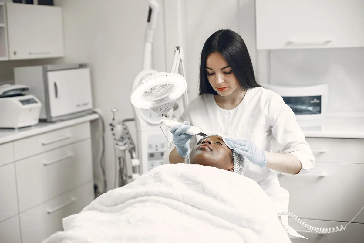 Esthetician giving a client a facial treatment